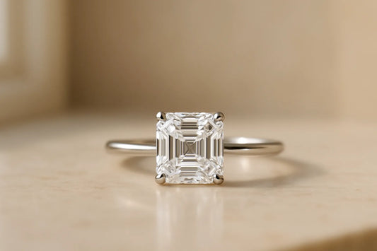 Asscher cut diamond solitaire engagement ring in white gold, showing the square outline and stepped facets