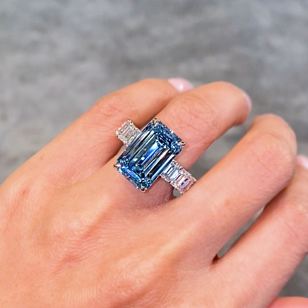 Blue Emerald Diamond Ring on a girls ring finger